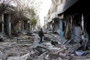 A Kurdish fighter walks through rubble in Kobani, Syria, Nov. 19, 2014 (AP photo by Jake Simkin).