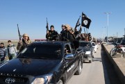 Islamic State militants pass by a convoy, Tel Abyad, northeast Syria, May 4, 2015 (Militant website via AP).