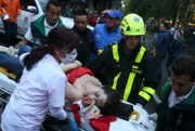 An injured woman is evacuated on a gurney after an explosion at the Centro Andino shopping center in Bogota, Colombia, June 17, 2017 (AP photo by Ricardo Mazalan).