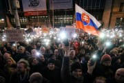 Demonstrators light the torches of their smartphones during an anti-government rally, Bratislava, Slovakia, April 15, 2018 (AP photo by Ronald Zak).