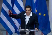 Greek Prime Minister Alexis Tsipras holds a tie at the end of a speech to lawmakers from his left-led governing coalition, Athens, Greece, June 22, 2018 (AP photo by Petros Giannakouris).