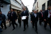 Peruvian President Martin Vizcarra walks to the Legislative Palace, the seat of Peru’s Congress, in Lima, to hand-deliver proposed legislation on political reform, on Aug. 9, 2018 (Photo by Anthony Nino De Guzman for GDA via AP Images).