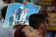 Supporters of the Cambodia National Rescue Party hold a poster of Sam Rainsy and Kem Sokha during the last day of campaigning for the June 4 commune elections, Phnom Penh, Cambodia, June 2, 2017 (AP photo by Heng Sinith).