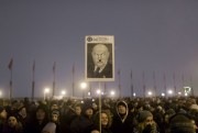 A protester holds a sign mocking Hungarian Prime Minister Viktor Orban during an anti-government march in central Budapest, Hungary, Dec. 21, 2018 (AP photo by Marko Drobnjakovic).