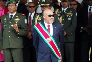 Surinamese President Desi Bouterse observes a military parade after being sworn in for his second term, in Paramaribo, Suriname, Aug. 12, 2015 (AP photo by Ertugrul Kilic).