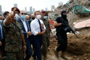 French President Emmanuel Macron, center, visits the devastated site of the explosion at Beirut’s port, Lebanon, Aug. 6, 2020 (AP photo by Thibault Camus).