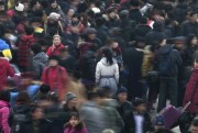 People rush to catch their train in Beijing.