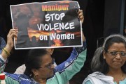 A protester holds a sign condemning gender-based violence in India.