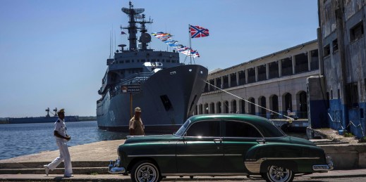 A Cuban sailor walks past the Russian navy training ship.
