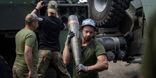 A Ukrainian soldier carries a 155mm shell for use in a Ukrainian-made Bohdana howitzer.