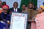 South African President Cyril Ramaphosa presents a certificate of recognition to King Misuzulu ka Zwelithini of the Zulu nation.