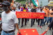 Exile Tibetans and local Indians participate in a protest against the Chinese government.