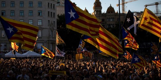 Demonstrators hold Catalan independence flags.