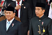 Indonesian President Joko Widodo walks with Defense Minister and President-elect Prabowo Subianto.