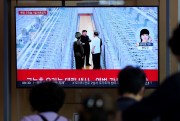 A TV screen shows an image of North Korean leader Kim Jong Un.