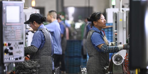 Workers produce gears at a workshop at a gear factory in Taizhou, Jiangsu province, China.