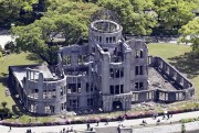 People walk past the Atomic Bomb Dome in Hiroshima, Japan.