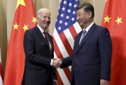 U.S. President Joe Biden shakes hands with Chinese President Xi Jinping.