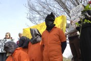 Demonstrators dressed as prisoners at Abu Ghraib protest the war in Iraq.