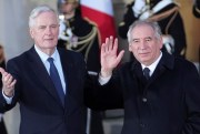 Outgoing French Prime Minister Michel Barnier, left, welcomes newly named Prime Minister François Bayrou.