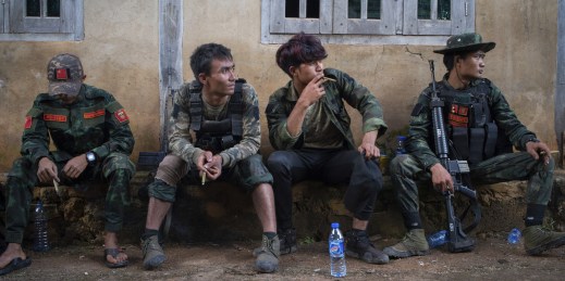 Opposition fighters take a break from a battle against the military junta.