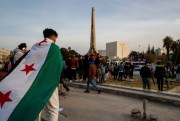 A man draped in the Syrian revolutionary flag.