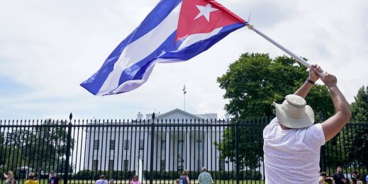 A man waving a Cuban flag in a rally outside the White House.