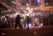 Demonstrators use firecrackers against police in Georgia.